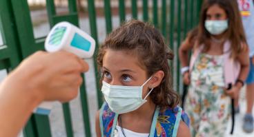 Student gets temperature checked at school