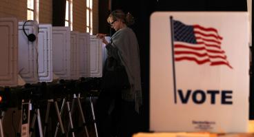 Woman casting her vote at the polls.