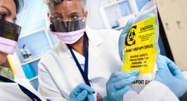 Doctor administering chemotherapeutic drugs