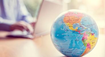 A globe sits on a desk.