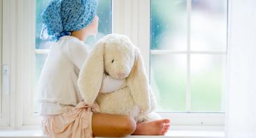 Child staring out of a window