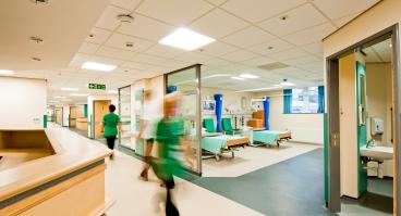 Nurses walk inside a hospital.