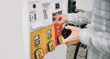 A person pays for gas at the pump.