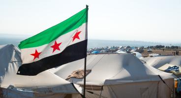 The Syrian revolution flag waves over refugee camps.