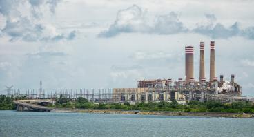 A Pemex refinery in Mexico, viewed from across a body of water.