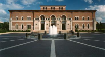 The front of Baker Hall, from across the plaza, with fountain in foreground