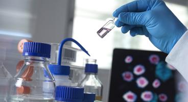 Scientist holding a vial