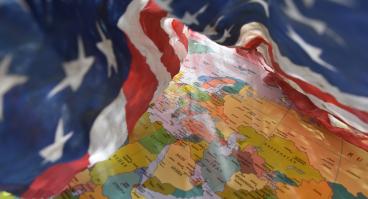 US flag drapes around Middle East regional map
