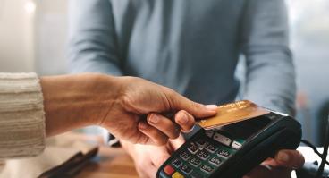 A person pays with credit card.