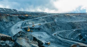Trucks and the excavator in an open pit 