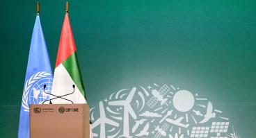 View of a lectern with flags of the United Nations and the United Arab Emirates
