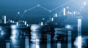 stacks of coins with graphs floating behind