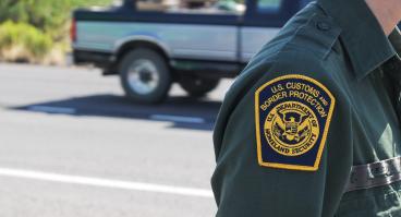 The U.S. Customs and Border Protection uniform patch of an agent standing on a road near an interior checkpoint in Southern Arizona