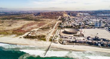 A drone shot look at the San Diego-Tijuana border from the pacific direction.