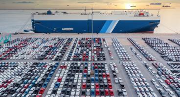 Aerial view vehicle carrier vessel loading car for shipping to worldwide, Large RoRo (Roll on/off) vehicle car carrier, New car lined up in the port for import export around the world.