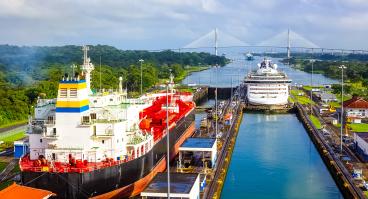 Two cargo ships transiting the Panama Canal.