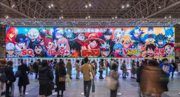 Huge placard showcasing manga heroes like Luffy featured in Weekly Jump magazine at the annual free event Jump Festa '23 in Makuhari Messe International Exhibition Hall.