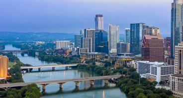 Colorado River and downtown city skyline of Austin at sunrise.