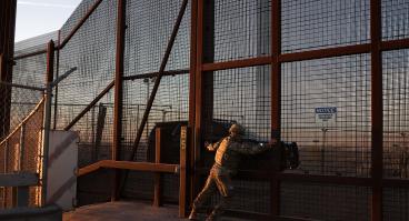A member of the Texas Military Department opens a fence along the US-Mexico border in El Paso, Texas on January 22, 2025. On his first day back in office US President Donald Trump declared a national emergency at the southern border "to repel the disastrous invasion of our country." 
