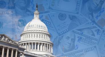 US Capitol building with dollar bills in background