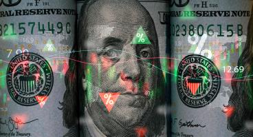 Benjamin Franklin face on USD dollar banknote with stock market chart and up down arrow for analysis investment.