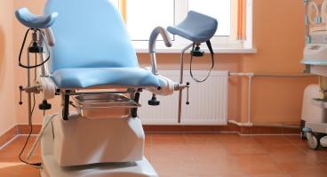 Gynecological exam chair in doctor's office