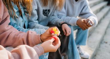 Children holding weed gummies