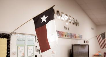 Texas and American flags displayed in pre-kindergarten classroom.