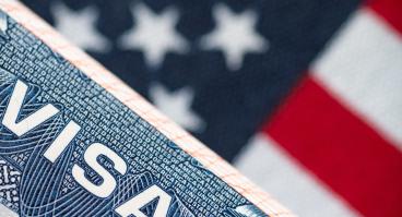 VISA to the USA and the flag of the United States of America. work and travel documents for visiting the USA. Visa for immigration.