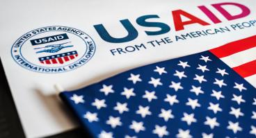 USAID logo letterhead and US flag in foreground 
