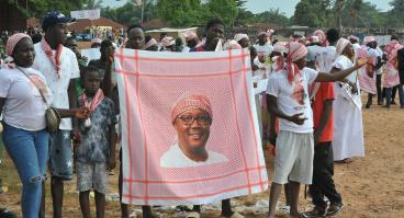 Supporters of President Umaro Sissoco Embalo show a red keffiyeh bearing his image during a political rally in Bissau