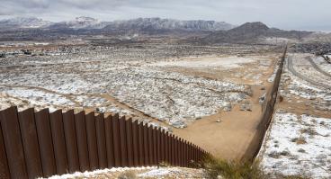 Snowy view of U.S.-Mexico border wall between Ciudad Juárez and El Paso