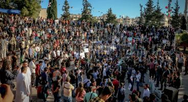 Unrecognizable crowd of ethnic protesters during rally on city street