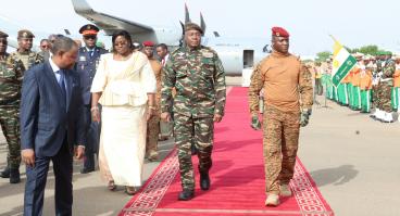 military officers on red carpet at airport