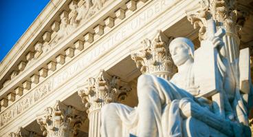  Equal Justice Under Law inscription in the neoclassical columned facade at the entrance to the US Supreme Court building in Washington DC 