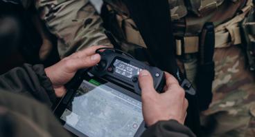 A group of Ukrainian military using tablet to operate the drone.