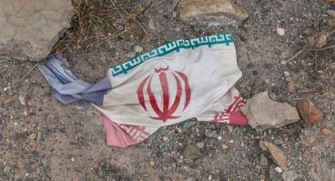 Iranian flag amidst debris