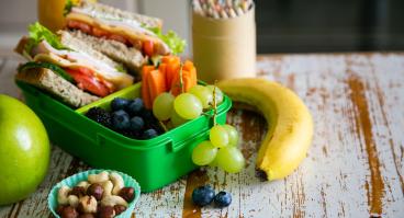 Packed school lunch on kitchen background