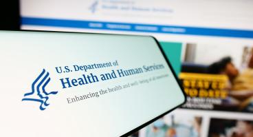 Mobile phone with logo of American Department of Health and Human Services (HHS)