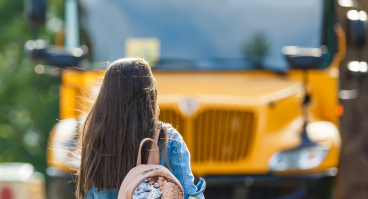 Student walking toward school bus