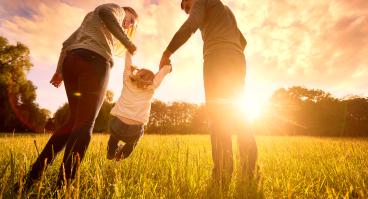 Parents hold the baby's hands
