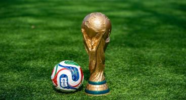  May 7, 2026, United States. The trophy of the 2026 FIFA World Cup and the official Adidas Trionda ball on the green lawn of the stadium. 