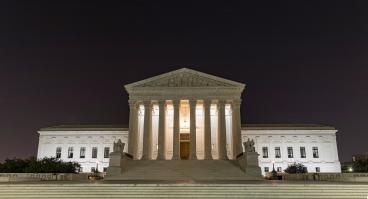 U.S. Supreme Cout Building at night under the crescent moon, Washington D.C.