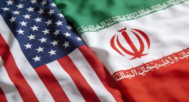 Close up view of the draped national flags representing the United States and Iran illustrating diplomatic relations issues.