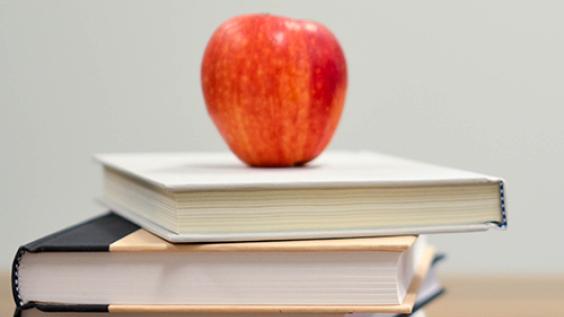Apple on top of stack of books