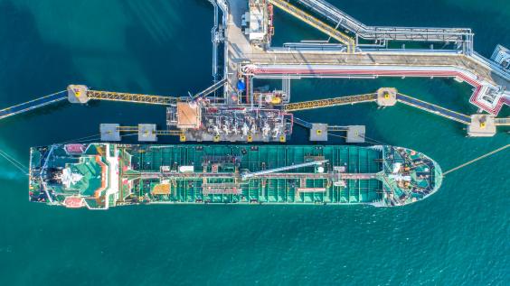 An oil tanker docks at a port.