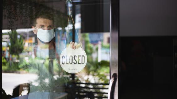 A man closes his business due to the COVID-19 pandemic.
