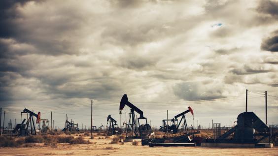 Many oil pumps at work in a field.
