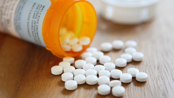 Prescription opioid medication pills spilled onto table