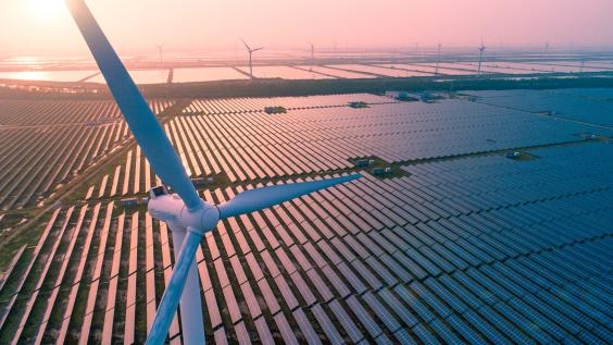 Wind turbine over solar farm